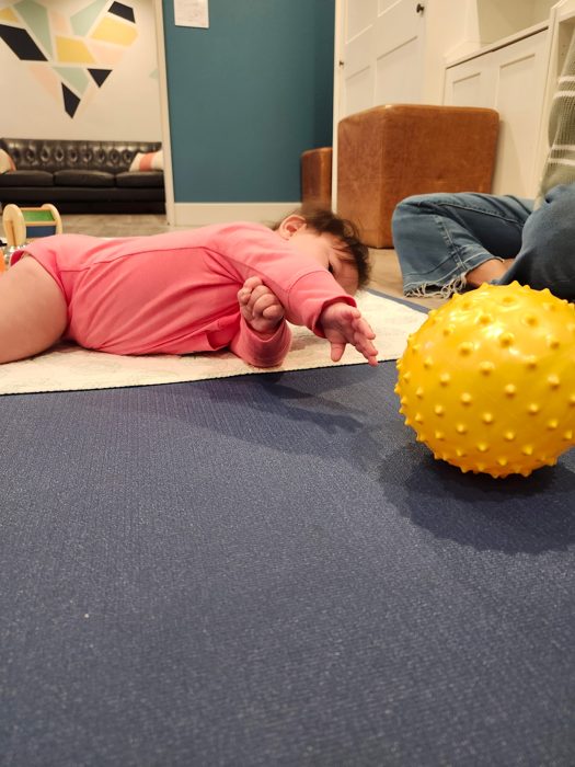 Dakota reaching for yellow ball