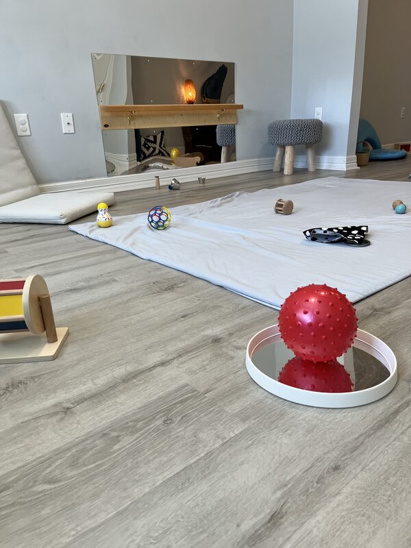 Infant with mirror and rug